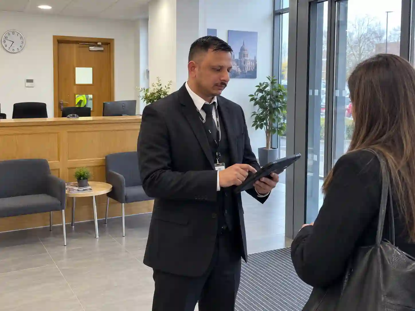 Concierge security officer managing visitor access control at a London office building